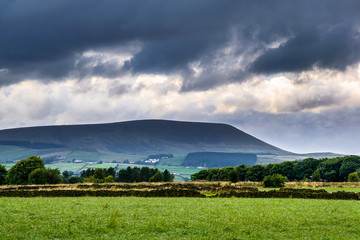 Wall Mural - Distance view from farm on Pendle Hill on cloudy summer afternoon