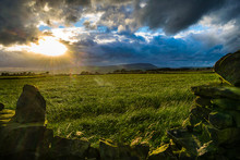 Stone Wall On The Farm With Direct Sun Light, Clouds Formation Over Forest Of Bowland In Distance Pendle Hill On Summer Afternoon