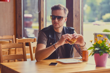 A man eating a vegan burger.