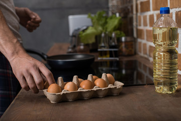 partial view of young man preparing food breakfast in kitchen at home