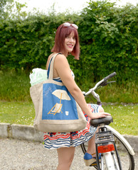 Wall Mural - Young attractive woman riding a bicycle