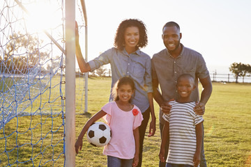 Portrait of a young black family during a football game