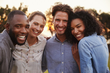 Portrait of two happy young couples smiling and embracing