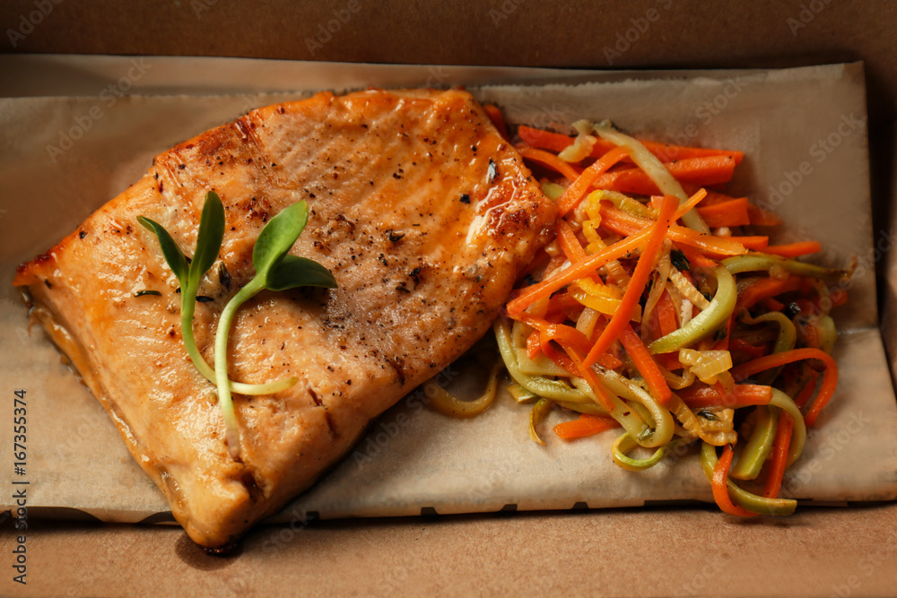 Cardboard box with delicious fish and vegetables, closeup