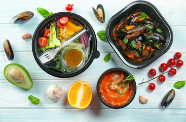 Sticker - Plastic containers with delicious food on wooden table