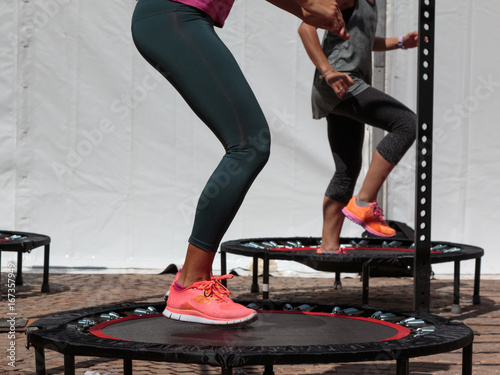Fotografía Mini Trampoline Workout: Girl doing Fitness Exercise in Class at Gym