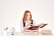 © pressmaster - Portrait of red-haired female student studying at desk