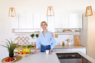 Pretty girl walks into kitchen and stretches, enjoying morning c