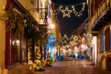 Traditional Alsatian half-timbered houses in old town of Colmar, decorated and illuminated at christmas time, Alsace, France