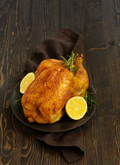 Wall Mural - Baked whole chicken with lemon and herbs.