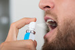 Man Spraying Breath Freshener