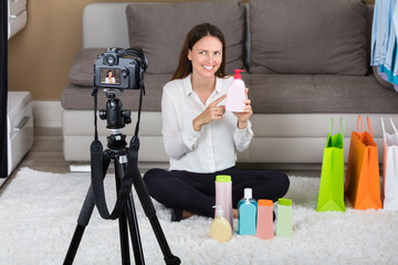 Young Woman Holding Cosmetic Product