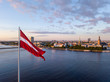 Beautiful aerial sunset view over AB dam in Riga Latvia with a huge Latvian flag