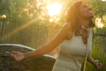 Excited African American woman with open arms.