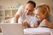 © liderina - Senior couple lying in bed and buying over the Internet by credit card.