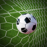 Fototapeta Młodzieżowe - Soccer football in Goal net with green grass field.