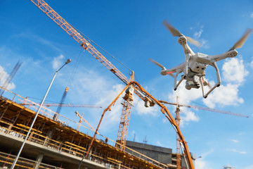 Wall Mural - drone over construction site. video surveillance or industrial inspection