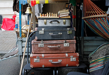 Still life of vintage suitcases, chess, books at city festival