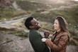 © Nicole Mason/Stocksy - young diverse couple laughing together
