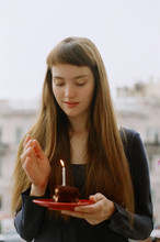 Young Woman Holding Birthday Cake