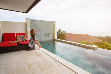 Love couple in luxury villa swimming pool. Nice view, hot summer day outdoor