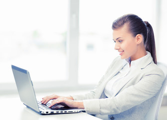 Wall Mural - businesswoman with laptop in office