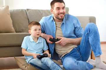 Poster - father and son playing video game at home