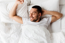 man lying in bed at home