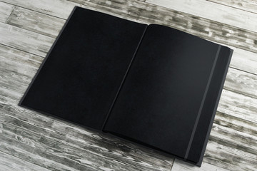 Wall Mural - Empty black notepad on wooden desktop