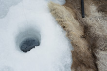 High Angle View Of Rug By Ice Fishing Hole At Abisko National Park