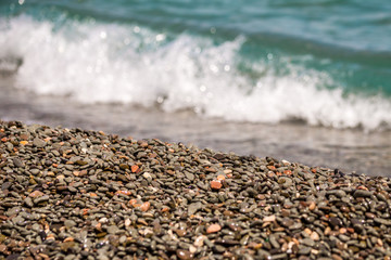 Beatiful foamy waves on a pebble beac