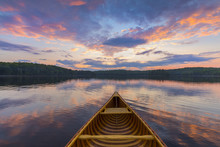 Bow Of A Cedar Canoe On A Lake At Sunset - Ontario, Canada
