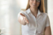 © fizkes - Female helping hand extended at camera for handshake, welcoming to cooperation concept, inviting at meeting, medical consultation, job interview, open to cooperation, good first impression, close up