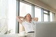 © fizkes - Satisfied happy businesswoman feeling relaxed sitting leaning back on ergonomic office chair, enjoying break, pleasant morning at workplace with hands behind head, eyes closed, finished all work done