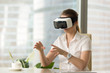 © fizkes - VR headset for business experience, curious woman wearing goggles touching 3d virtual objects seem like real, young businesswoman exploring augmented reality simulation with hands, try before you buy