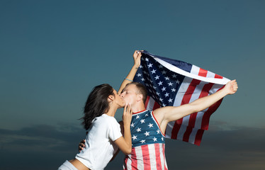 Wall Mural - Loving couple kissing outdoor at sunset - Concept about people, love and lifestyle. Sensual. Couple in love. American