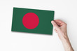 © ink drop - Male hand holding bangladesh flag