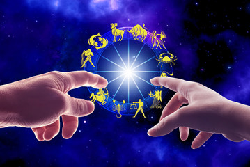 woman and man hand touching zodiac wheel with signs like astrology concept 