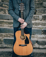 Wall Mural - Man's hands playing acoustic guitar. Background