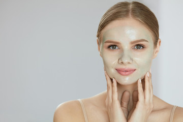 Cosmetic Mask. Beautiful  Smiling Woman Applying Mask On Face