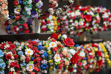  Colorful traditional flower wreath on sale on local market.