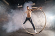 Strong circus performer spinning a cyr wheel