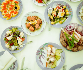 Wall Mural - Restaurant table with plates salad, meat and vegetables