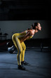 © Михаил Решетников - Attractive muscular woman lifting heavy dumbbells  on indoors