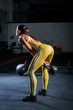 © Михаил Решетников - Attractive muscular woman lifting heavy dumbbells  on indoors
