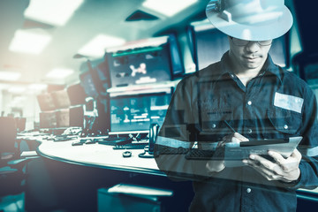 Double exposure of  Engineer or Technician man in working shirt  working with tablet in control room of oil and gas platform or plant industrial for monitor process, business and industry concept