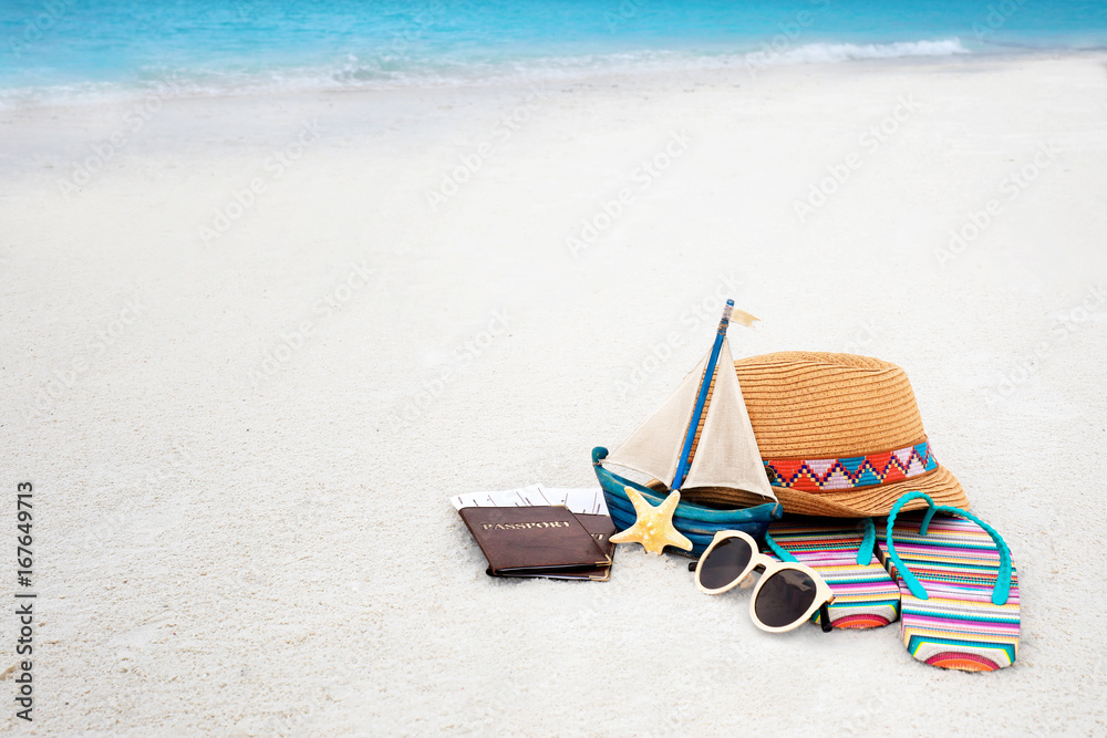 Passports and tickets with beach accessories on sand. Summer vacation concept