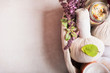 Massage setting with herbal compress balls ,fresh herbs and flowers and bathroom salts  on light background,top view. Healthy Lifestyle or Spa and wellness concept