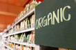 Organic food signage on modern supermarket grocery aisle