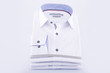 Men's shirts are white, folded, new on a white background